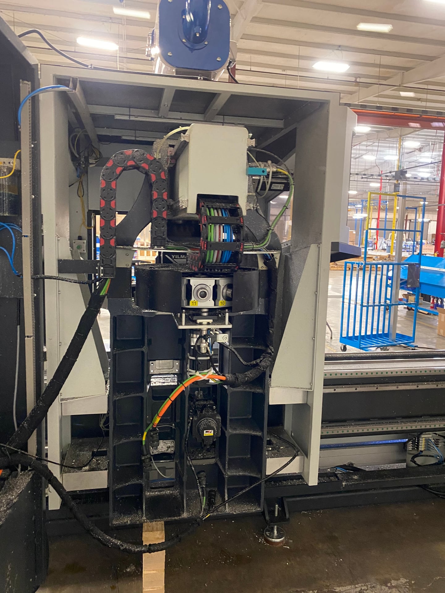 Industrial robotic machine with complex wiring in manufacturing facility